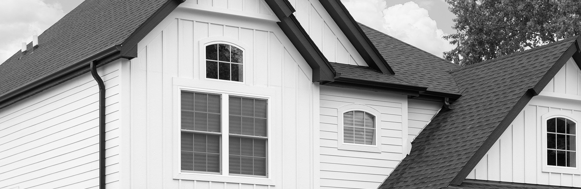 Professionally installed white siding using industry-leading siding boards