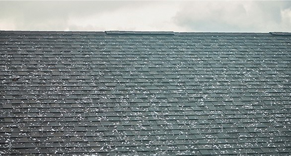 Dents in roof shingles caused by hail