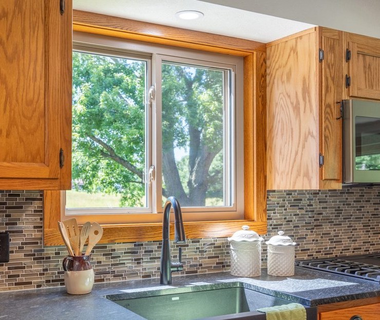 Classic white slider windows installed over kitchen sink